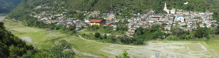 Panoramic image of Belac&#225;zar Village eight years after the 2008 lahar innundation. Lahar deposits in the foreground of the town are now soccer fields and a dirt bike track. (Click image to view full size.)