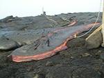 Lava moves beyond rope, with muffled sounds of methane explosions, Kilauea volcano, Hawai`i