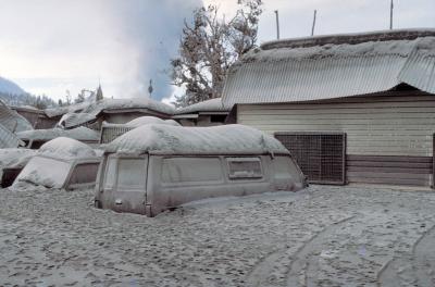 Ash buries cars and buildings after the 1984 eruption of Rabaul, Papua New Guinea. 
 (Click image to view full size.)