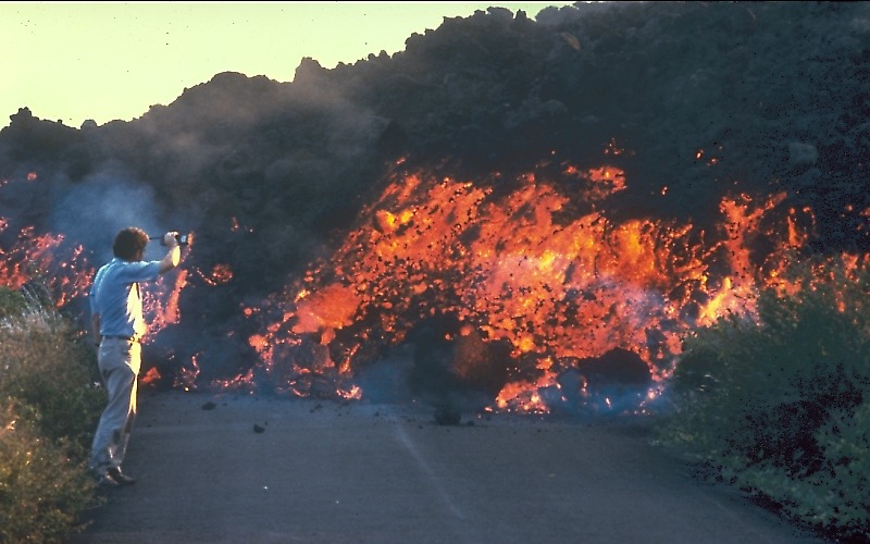 ‘A‘ā flow from Pu‘u ‘Ō‘ō advances down a street in Royal Gardens subdivision, Kīlauea Volcano, Hawai‘i.