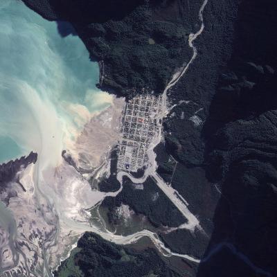 Heavy rains in May 2008 remobilized ash laid down by the eruption of Volcan Chaiten, in southern Chile. Although evacuated, this rendered much of the town of Chaiten (visible in photo) uninhabitable. (Click image to view full size.)